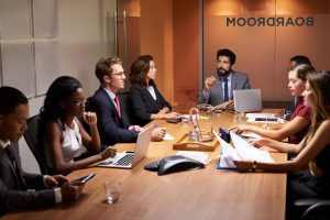 a group of people sitting around a conference table.